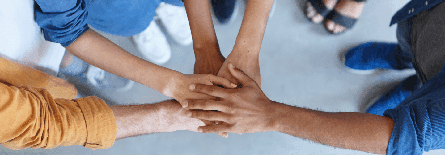 Team members joining hands